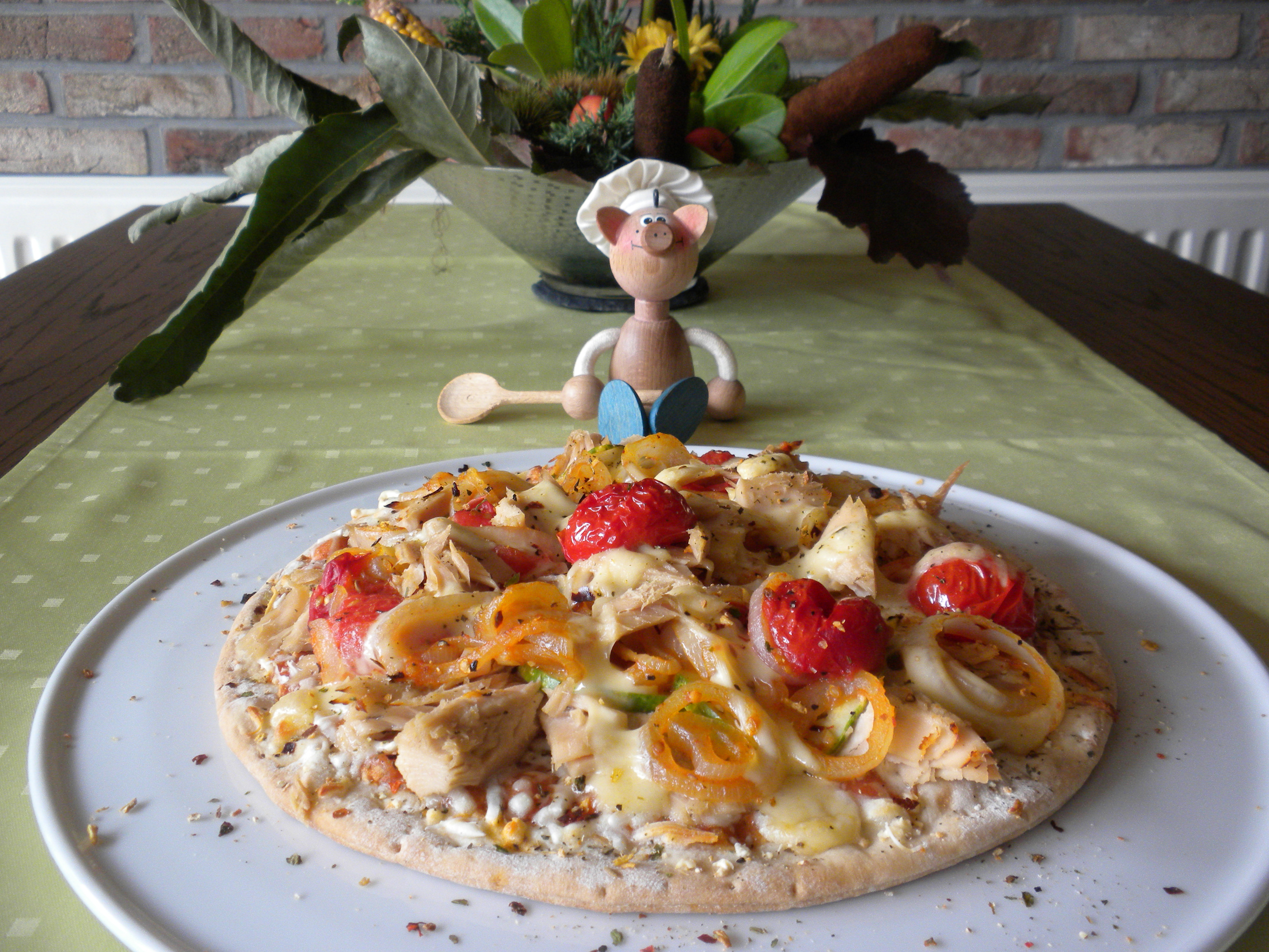 Pizza rijkelijk gevuld met witte tonijn en zijn garnituren op provencaalse wijze