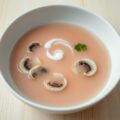 Roze consommé van Parijse champignons