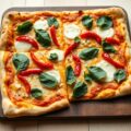 Plaatpizza met spinazie en twee soorten kaas