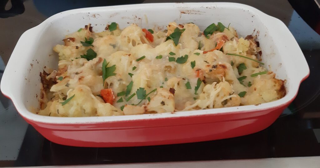 Vegetarische ovenschotel bloemkool, aardappelblokjes, paprika, prei en roomkaas