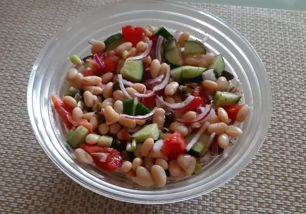 Witte bonensalade met komkommer, tomaat, kappertjes en rode ui