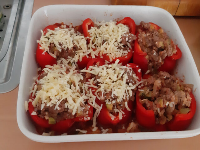 Gevulde paprika’s met gehakt en kaas op een lekkere tomaten-courgettesaus.