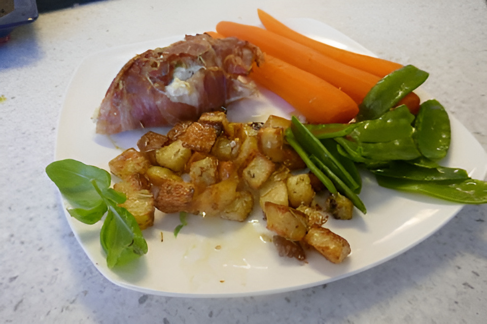 Met ricotta gevuld kipfileetje gerold in Parmaham van de bakplaat.
