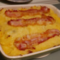 Bruine bonen ovenschotel met appel, gebakken uien, spekjes en aardappelpuree